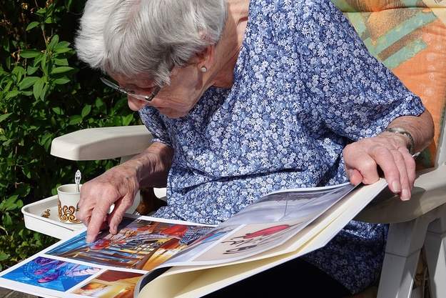 Elderly woman holding a photo-album