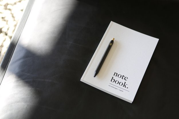 White notebook with pen