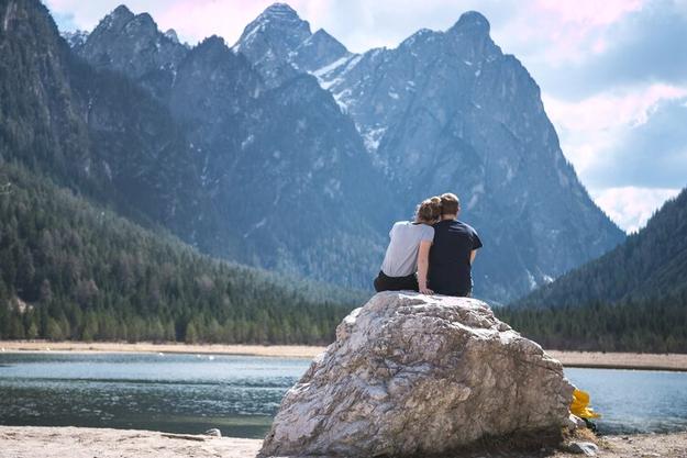 Man and woman sitting on a stone