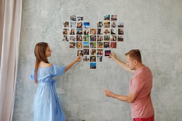 couple looks at photo collage