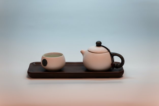 White ceramic teapot and cup