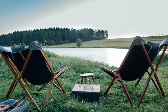 two-camping-chairs-near-the-river